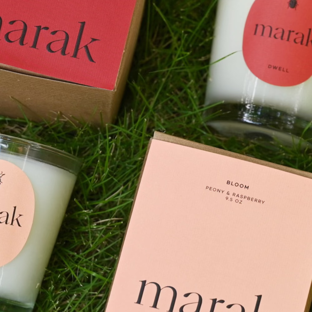 Marak candles and packaging on grass